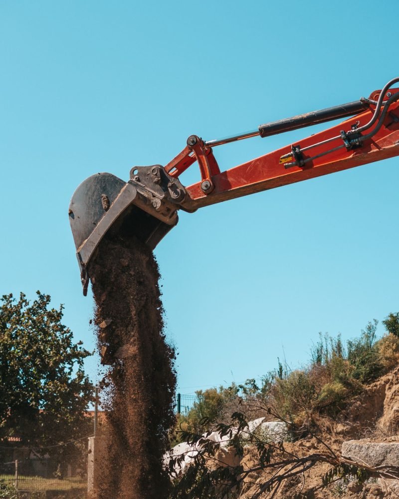 closeup-of-a-backhoe-with-dirt-against-sky-2024-12-04-01-41-54-utc
